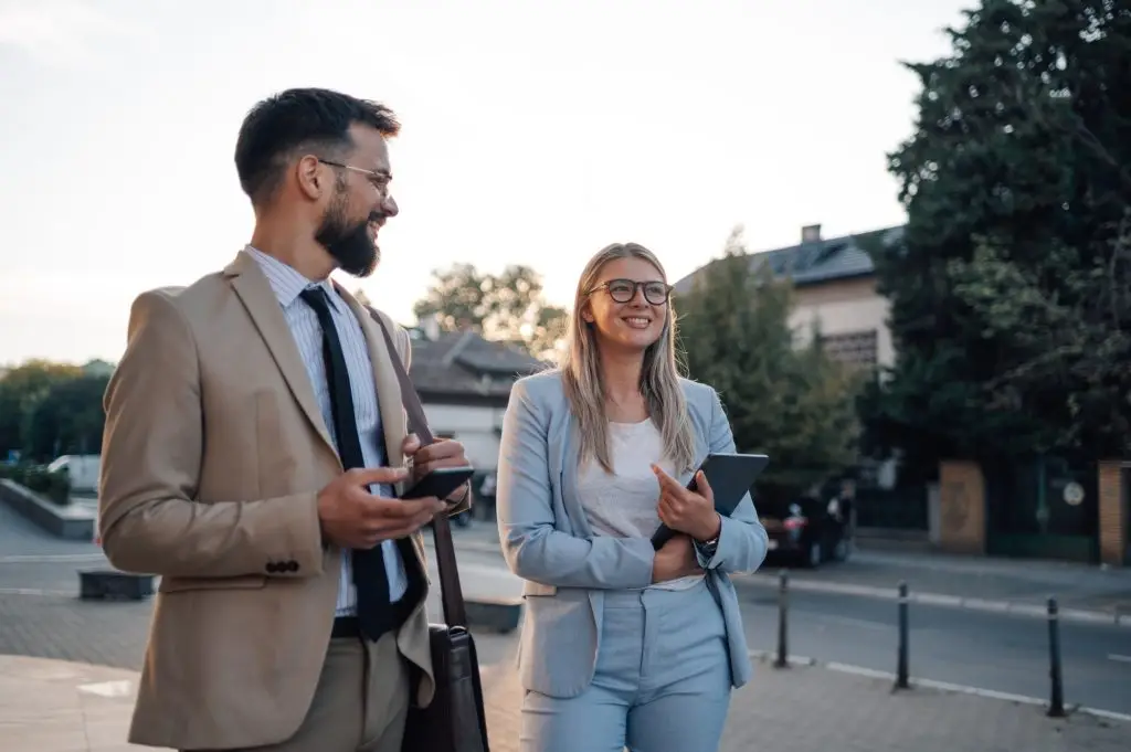 Businesspeople using technology and walking in the city