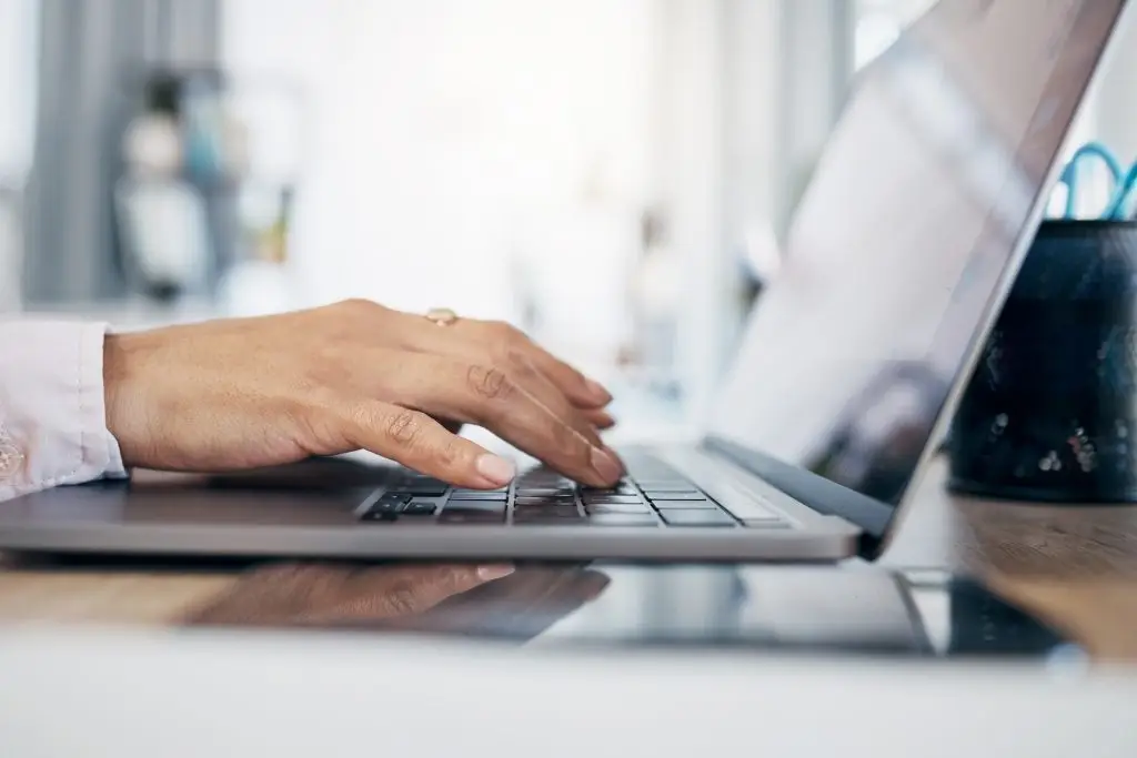 Laptop, hands and office person typing administration work, secretary project or company web report